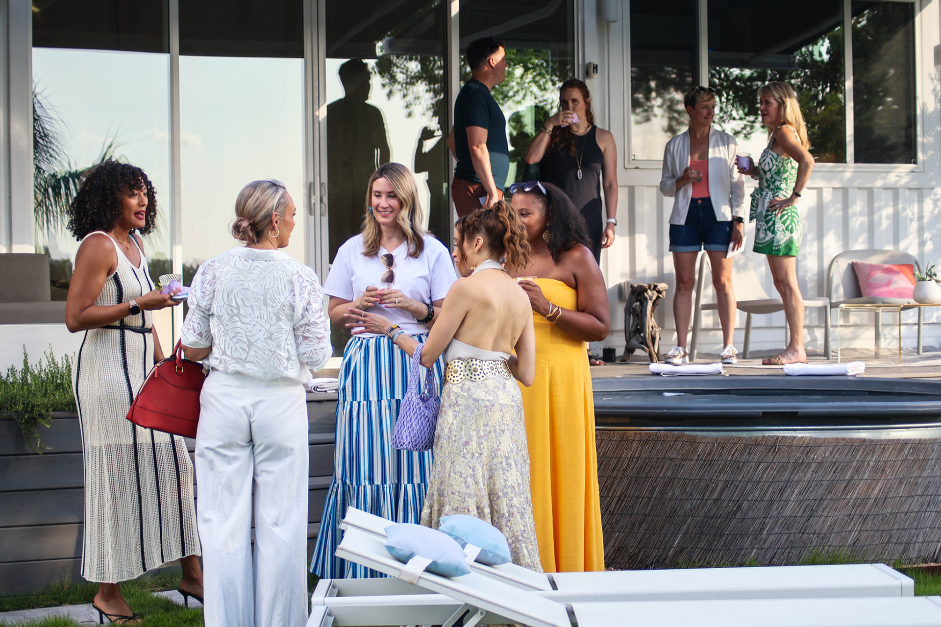 Guests talking beside the pool deck outside the indoor space