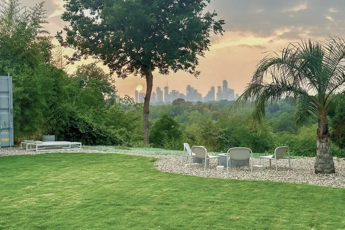 Skyline-facing, tree-shaded lawn and lounge with sunset views over downtown Austin